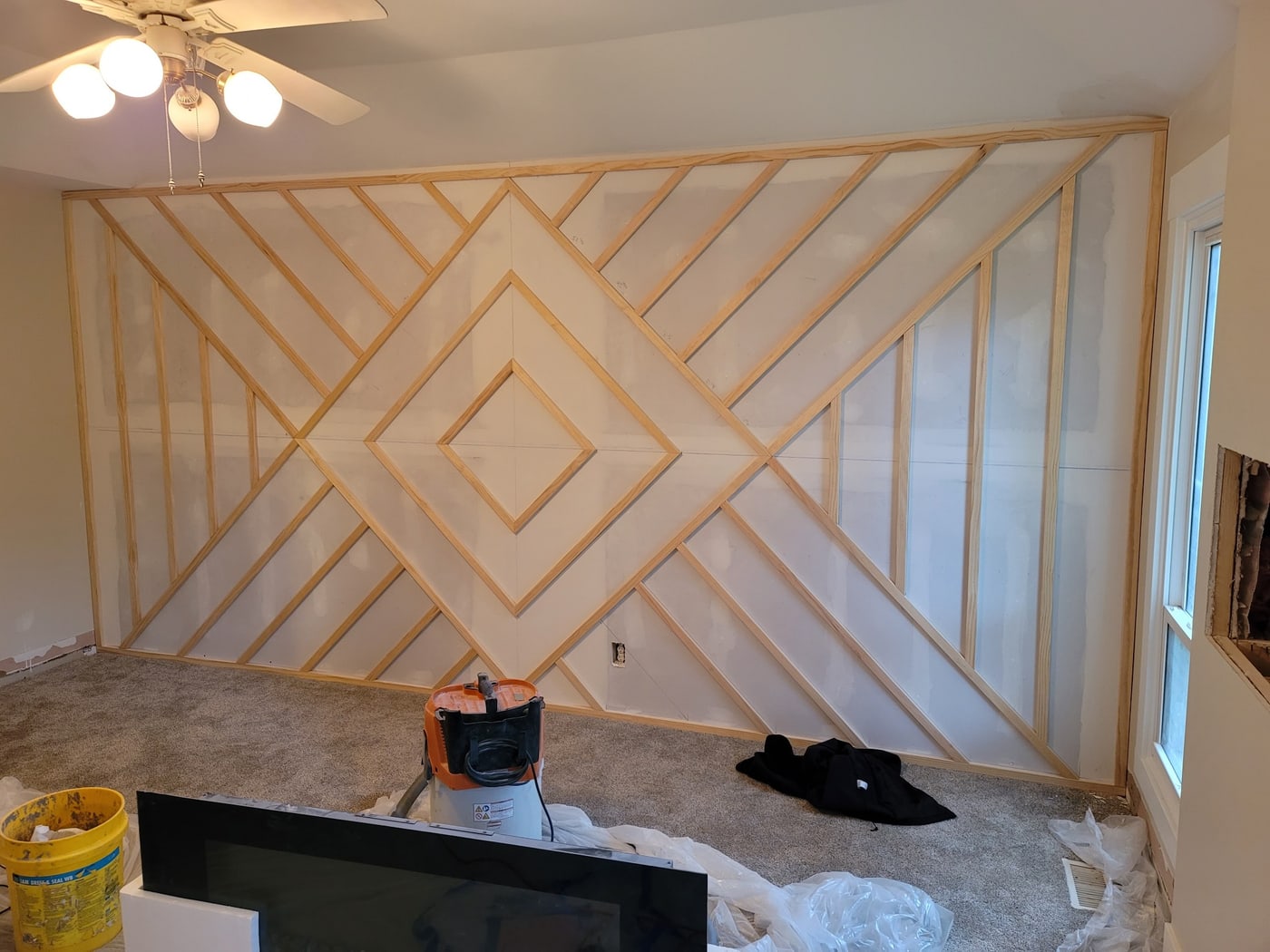 A geometric wood-slat accent wall by Hansen Construction, Bellevue